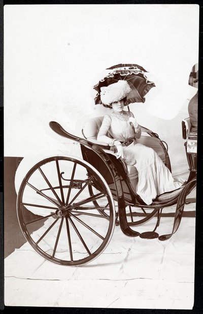 A Fashion Model Seated in a Carriage Holding a Parasol by Byron Company